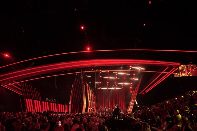 A large auditorium illuminated by red lights